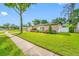 Well-maintained home with a lush green lawn, mature landscaping, and a charming exterior, reflecting pride of ownership at 4220 Woodlark Dr, Tampa, FL 33624