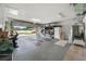 Spacious garage with overhead lighting, epoxy flooring, storage shelving, and an open garage door at 4220 Woodlark Dr, Tampa, FL 33624