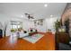 Bright living room with wood floors, modern decor, and sliding glass doors to the backyard at 4220 Woodlark Dr, Tampa, FL 33624