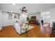 Open-concept living room features wood floors, modern brick accent wall, and a ceiling fan at 4220 Woodlark Dr, Tampa, FL 33624