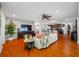 Open concept living room and kitchen featuring wood floors and brick accent wall at 4220 Woodlark Dr, Tampa, FL 33624