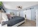 Comfortable main bedroom features modern decor, light blue walls, barn door to bathroom at 4220 Woodlark Dr, Tampa, FL 33624