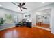 Open concept office with a ceiling fan, wood floors, and natural light streaming in through a large window at 4220 Woodlark Dr, Tampa, FL 33624