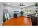 A well-lit office with a ceiling fan, sleek wood floors, and a large window at 4220 Woodlark Dr, Tampa, FL 33624