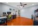 Open concept office featuring hardwood floors, ceiling fan, and a view into another room at 4220 Woodlark Dr, Tampa, FL 33624