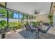 Screened-in lanai featuring black metal table and chairs, a patterned rug, and a ceiling fan at 4220 Woodlark Dr, Tampa, FL 33624