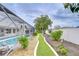 A charming backyard featuring a well-maintained garden path and access to a sparkling screened-in pool area at 4368 Las Palmas Ave, Spring Hill, FL 34606