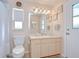 Bathroom with a single vanity, toilet, shower with curtain, neutral walls, and updated lighting at 4368 Las Palmas Ave, Spring Hill, FL 34606