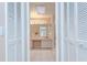 Bathroom view through shutters showcasing a vanity, mirror, and updated lighting at 4368 Las Palmas Ave, Spring Hill, FL 34606