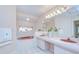Bright bathroom featuring dual vanity sinks, soaking tub with stained glass window, and tile flooring at 4368 Las Palmas Ave, Spring Hill, FL 34606