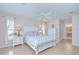 Bright, spacious main bedroom with a white furniture, ceiling fan, and an ensuite bathroom at 4368 Las Palmas Ave, Spring Hill, FL 34606