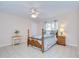 Bedroom featuring wood-frame bed, ceiling fan, tile flooring, and natural light at 4368 Las Palmas Ave, Spring Hill, FL 34606