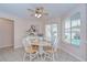 Cozy dining room with a ceiling fan, neutral colors, a table with 4 chairs, and bright natural light at 4368 Las Palmas Ave, Spring Hill, FL 34606
