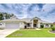Charming single-story home featuring a well-manicured lawn, arched entryway, and a two-car garage at 4368 Las Palmas Ave, Spring Hill, FL 34606