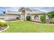 Beautiful exterior view of home's front with a well-maintained lawn and manicured landscaping at 4368 Las Palmas Ave, Spring Hill, FL 34606