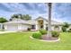 Inviting single-story home with a well-manicured lawn and landscaping, plus neutral exterior paint and tile roof at 4368 Las Palmas Ave, Spring Hill, FL 34606