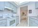 Functional kitchen with white appliances, ample storage, and a pass-through to the dining area at 4368 Las Palmas Ave, Spring Hill, FL 34606
