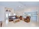 Spacious living room featuring hardwood floors, vaulted ceilings, and a seamless flow to the kitchen at 4368 Las Palmas Ave, Spring Hill, FL 34606