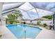 Sparkling screened-in pool, landscaped surroundings, and plenty of privacy in a tranquil backyard setting at 4368 Las Palmas Ave, Spring Hill, FL 34606