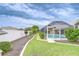 Backyard view with a screened-in pool and lush green lawn, separated by a white fence at 4368 Las Palmas Ave, Spring Hill, FL 34606