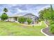 Inviting screened-in pool area with lush landscaping and well-maintained lawn surrounding the home at 4368 Las Palmas Ave, Spring Hill, FL 34606