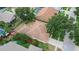 Aerial view of a single Gathering home featuring a large roof, mature trees and well-maintained landscaping at 4418 River Overlook Dr, Valrico, FL 33596