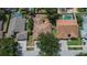 Aerial view of a home with a brown roof in a suburban neighborhood with mature trees at 4418 River Overlook Dr, Valrico, FL 33596