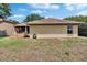 Exterior view of the home's backyard, showing the grass and part of the house at 4418 River Overlook Dr, Valrico, FL 33596