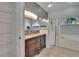 Well-lit primary bathroom boasting dual sinks, large mirrors, a glass shower, and a soaking tub at 4418 River Overlook Dr, Valrico, FL 33596