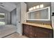 Primary bathroom with double sinks, granite countertop, and access to the walk-in closet at 4418 River Overlook Dr, Valrico, FL 33596