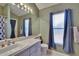 Well-lit bathroom features a large mirror, vanity, and modern fixtures at 4418 River Overlook Dr, Valrico, FL 33596