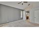 Large primary bedroom featuring neutral walls, carpet, and an en-suite bathroom at 4418 River Overlook Dr, Valrico, FL 33596