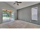 Neutral bedroom featuring carpet flooring, neutral paint and slider access to the screened lanai at 4418 River Overlook Dr, Valrico, FL 33596