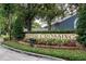 River Crossing community sign featuring colorful flowers, lush greenery, and brick border at entrance at 4418 River Overlook Dr, Valrico, FL 33596