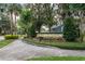 The River Crossing community sign is surrounded by lush greenery and trees, marking the neighborhood's entrance at 4418 River Overlook Dr, Valrico, FL 33596