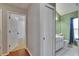 Hallway with a view into a bathroom with nice vanity and framed mirror at 4418 River Overlook Dr, Valrico, FL 33596