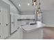 Bright kitchen with white cabinets, breakfast bar, modern appliances, and stylish pendant lighting at 4418 River Overlook Dr, Valrico, FL 33596