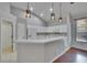 Bright kitchen features white cabinets, stainless steel appliances, and modern pendant lighting at 4418 River Overlook Dr, Valrico, FL 33596