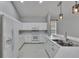 Bright kitchen featuring white appliances and tile floor, with a breakfast bar overlooking the dining area at 4418 River Overlook Dr, Valrico, FL 33596