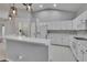 Well-lit kitchen with white cabinets, appliances, breakfast bar and tile flooring at 4418 River Overlook Dr, Valrico, FL 33596