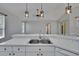 Modern kitchen with breakfast bar and stainless steel sink, open to the living area at 4418 River Overlook Dr, Valrico, FL 33596