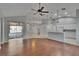 Open living area boasts hardwood floors and flows into a sunroom, with modern lighting fixtures at 4418 River Overlook Dr, Valrico, FL 33596