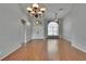 Bright living room featuring wood floors, high ceilings, neutral walls, and a double-door entryway at 4418 River Overlook Dr, Valrico, FL 33596