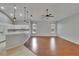Open-concept living room features wood floors and ample natural light, with pendant lighting and a ceiling fan at 4418 River Overlook Dr, Valrico, FL 33596