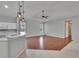 Open-concept kitchen and living area featuring hard wood floors and a breakfast bar at 4418 River Overlook Dr, Valrico, FL 33596