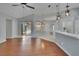 The living room leads to a sunroom with sliding glass doors, and modern pendant lights at 4418 River Overlook Dr, Valrico, FL 33596