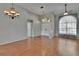 Bright living room featuring wood floors, high ceilings, neutral walls, and a double-door entryway at 4418 River Overlook Dr, Valrico, FL 33596