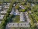Aerial view showcasing the condo community with a pond and community pool at 500 New York Ave # 23, Dunedin, FL 34698