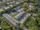 Aerial view showcasing condo community with central pond, fountain, and swimming pool amenities at 500 New York Ave # 23, Dunedin, FL 34698