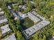Community aerial view featuring a serene pond, fountain and community pool at 500 New York Ave # 23, Dunedin, FL 34698